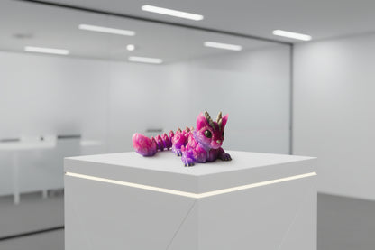 Purple and gray dragon toy on a wooden surface 